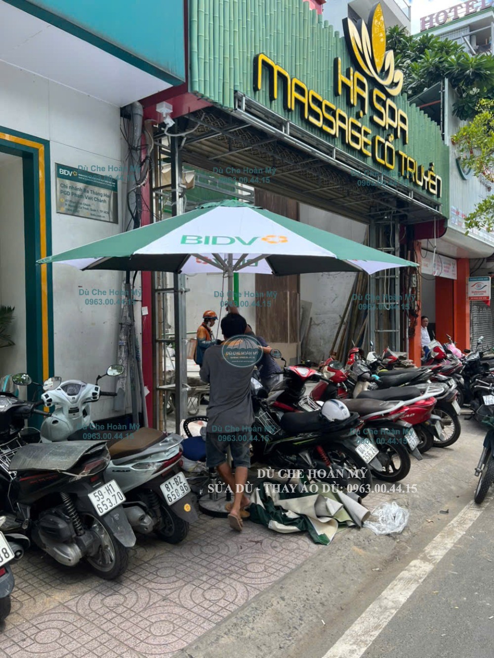 Thao tác kiểm tra bộ dù tròn đúng tâm BIDV giữa khu vực đỗ xe máy.